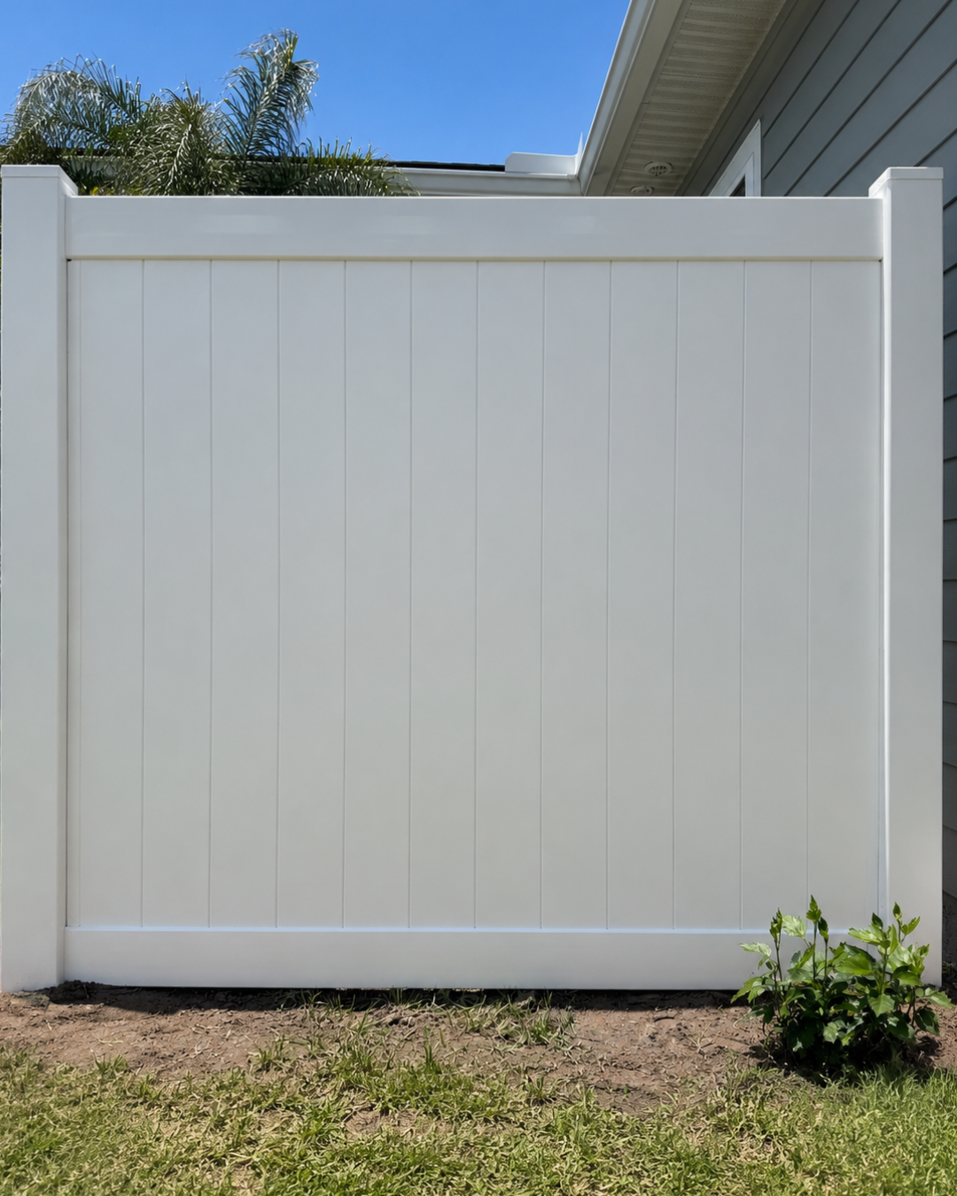 White vinyl privacy fence section in a Jacksonville, FL backyard