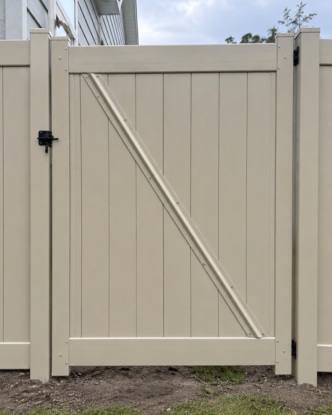 Tan pre-built vinyl privacy gate for a St. Augustine, FL fence